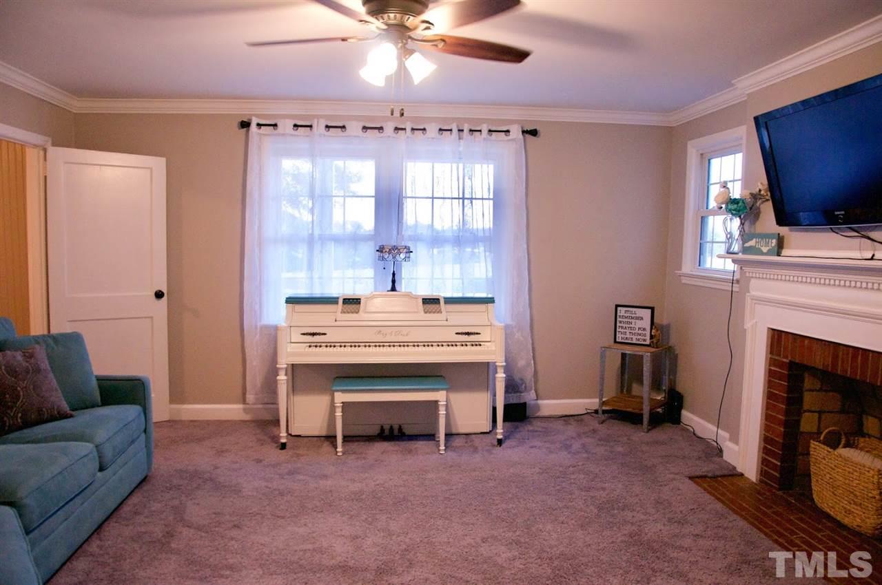 2120 Mary Hobby Road Raleigh, NC 27603 - Photo 10 of 30 a living room with furniture and a fireplace