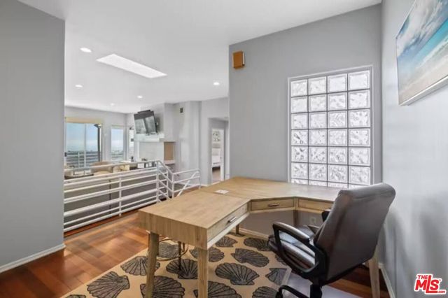 a large white kitchen with a large window