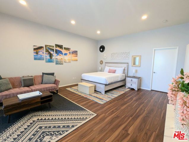 a bedroom with a large bed and a window