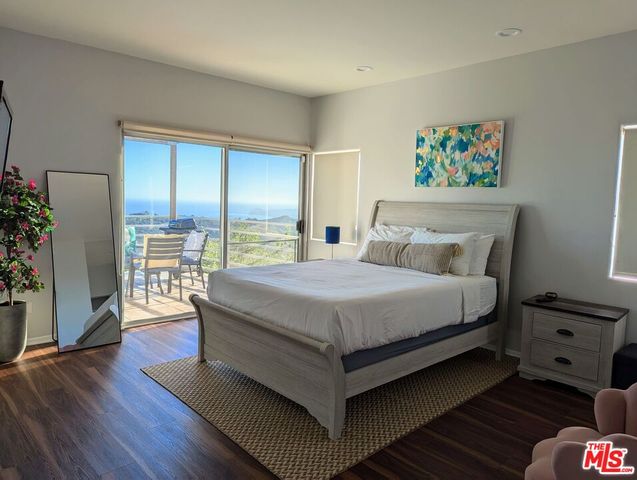 a bedroom with furniture and a wooden floor