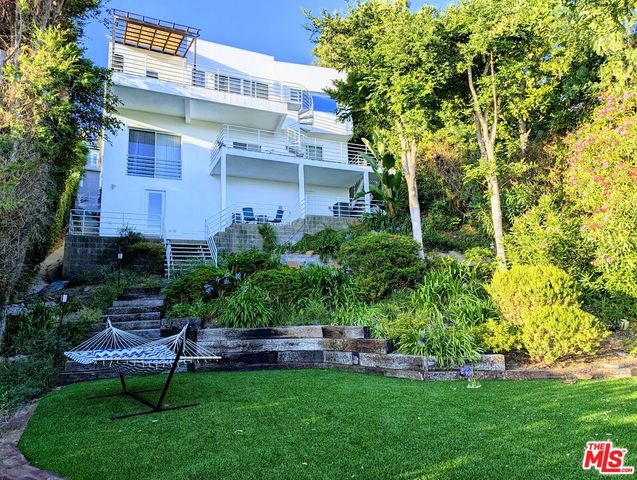 a view of a chair and table in front of a house