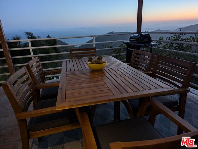 a view of a chairs and tables in the back yard of the house