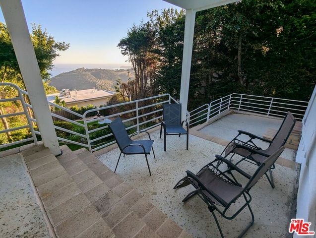a view of a chairs and table in patio