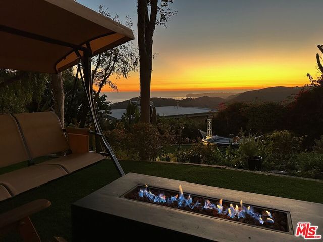 an aerial view of a balcony with chairs