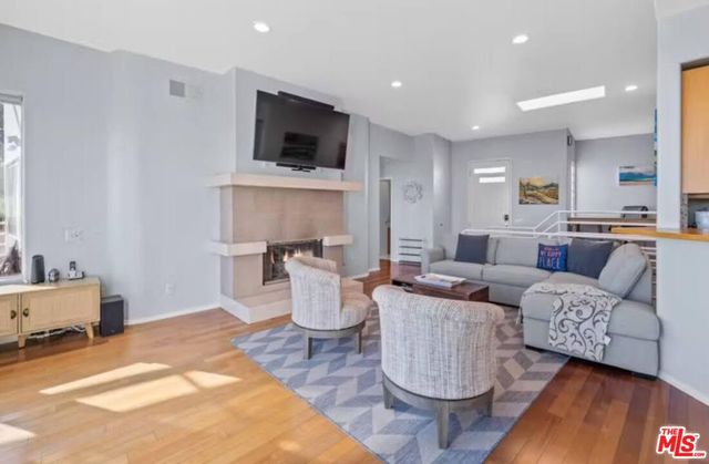 a living room with fireplace furniture and a wooden floor