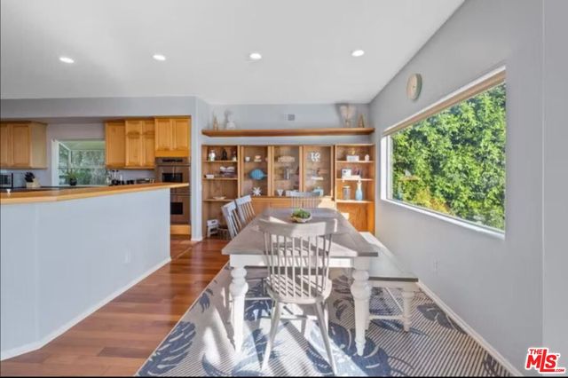 a room with a workspace and a bookshelf