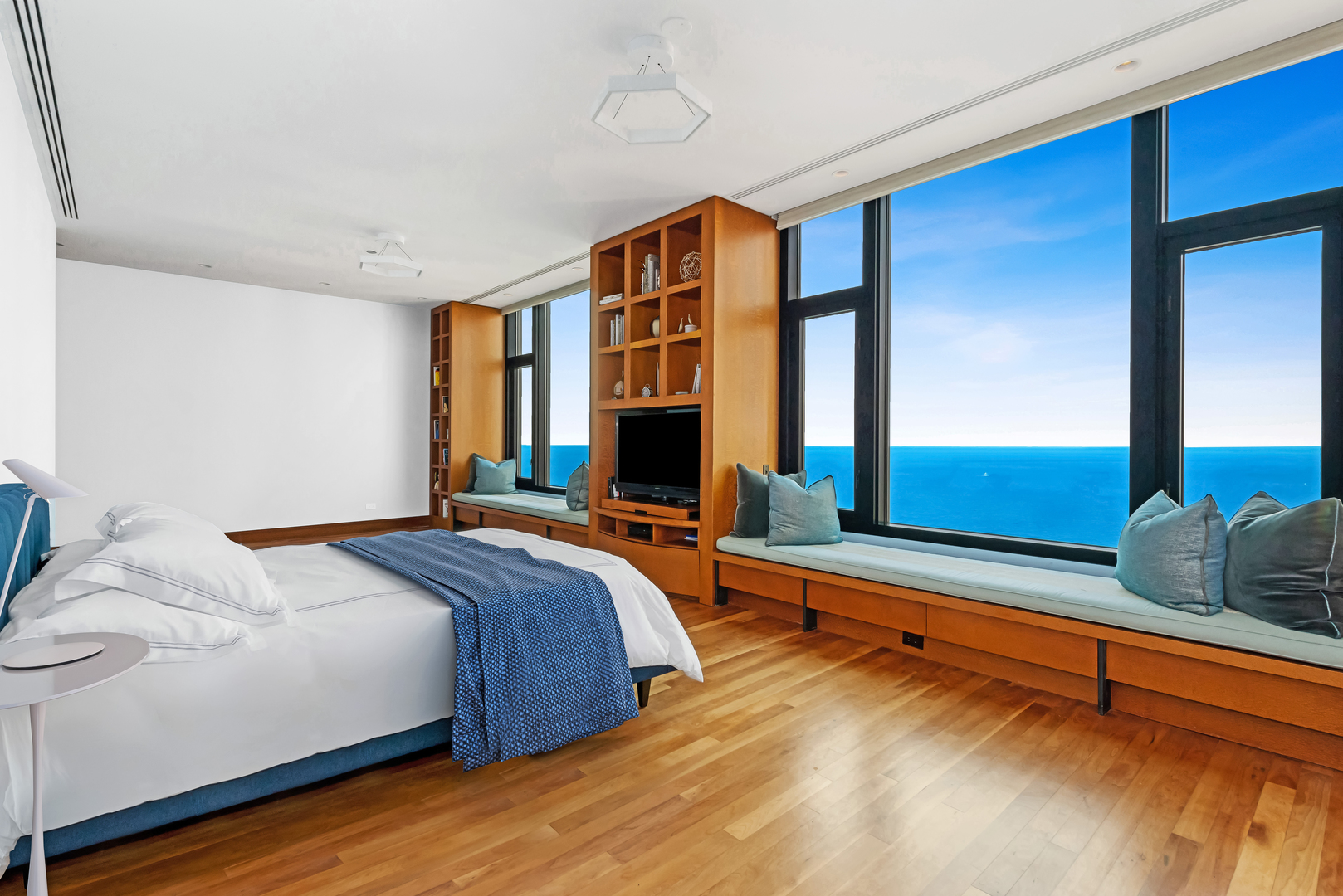 132 East Delaware Place, Unit 6502 Chicago, IL 60611 - Photo 13 of 27 a bedroom with a bed and two large window