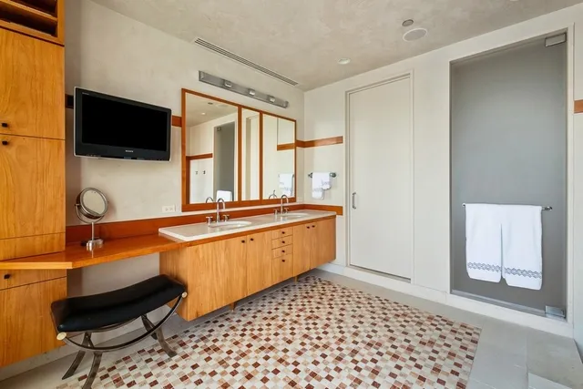 a room with a large mirror and furniture