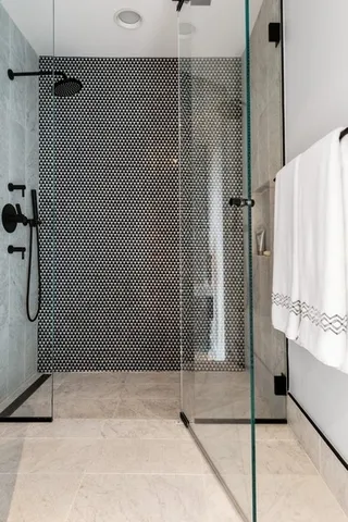 a bathroom with a shower and a sink