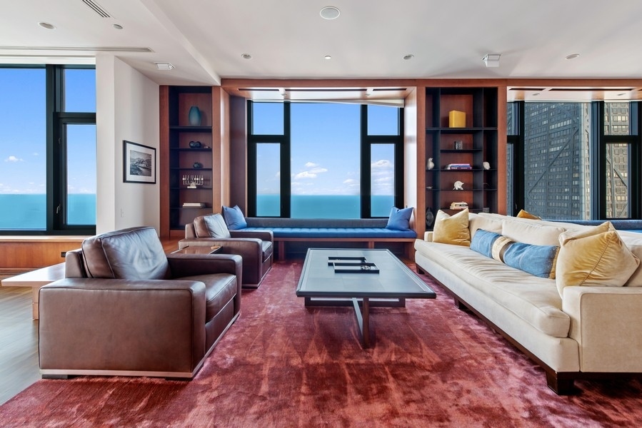 132 East Delaware Place, Unit 6502 Chicago, IL 60611 - Photo 3 of 27 a living room with furniture and floor to ceiling windows