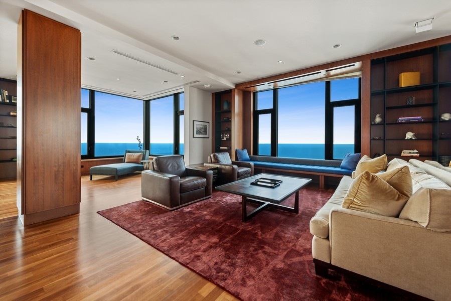 132 East Delaware Place, Unit 6502 Chicago, IL 60611 - Photo 4 of 27 a living room with furniture and a rug