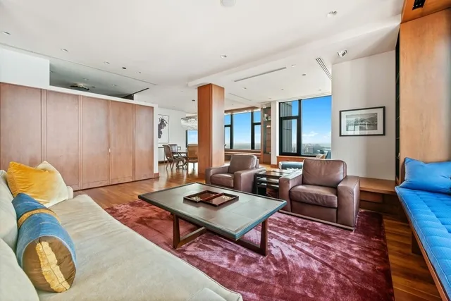 a living room with furniture rug and wooden floor