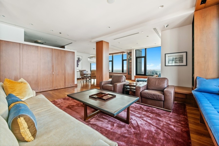 132 East Delaware Place, Unit 6502 Chicago, IL 60611 - Photo 5 of 27 a living room with furniture rug and wooden floor