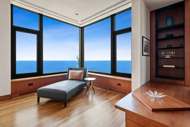 a living room with furniture and a air conditioner vent