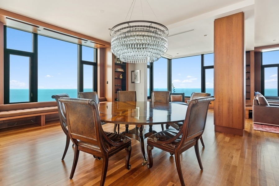 132 East Delaware Place, Unit 6502 Chicago, IL 60611 - Photo 8 of 27 a view of a dining room with furniture window and wooden floor