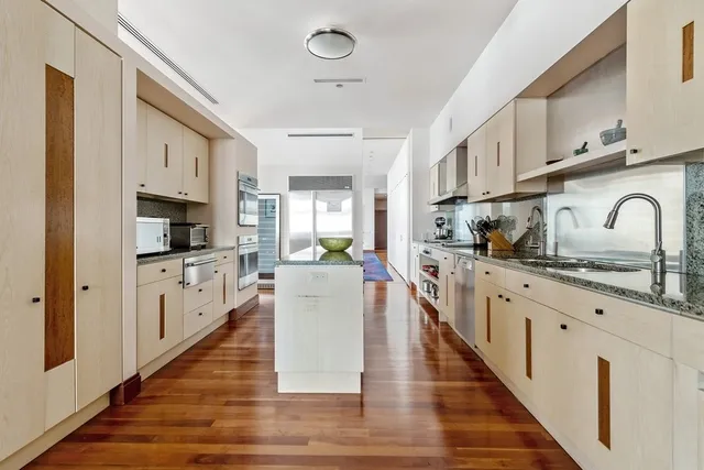 a kitchen with sink stove top oven and refrigerator