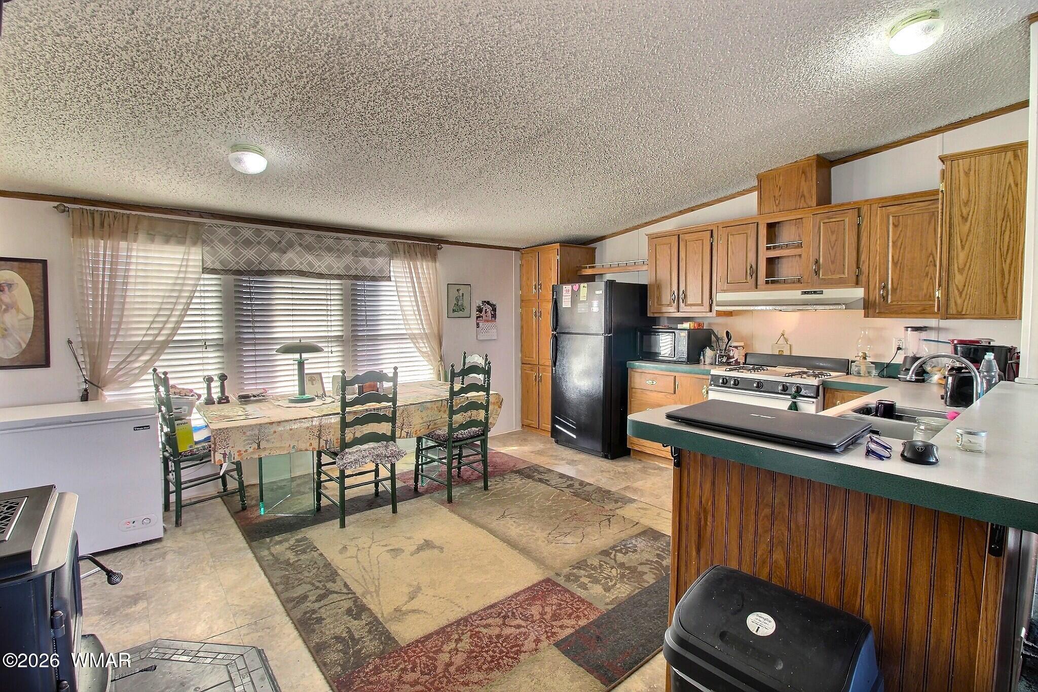 4710 Hay Hollow Road Snowflake, AZ 85937 - Photo 9 of 20 a kitchen with stainless steel appliances granite countertop a refrigerator stove microwave and sink