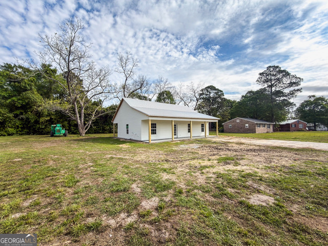 352 College Street Southwest Pelham, GA 31779 - Photo 1 of 1 a front view of a house with garden