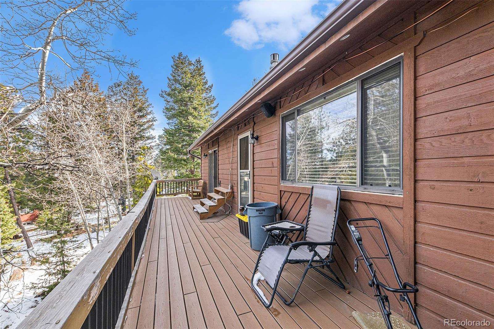 22296 Cook Lane Morrison, CO 80465 - Photo 12 of 19 a balcony with wooden floor and furniture
