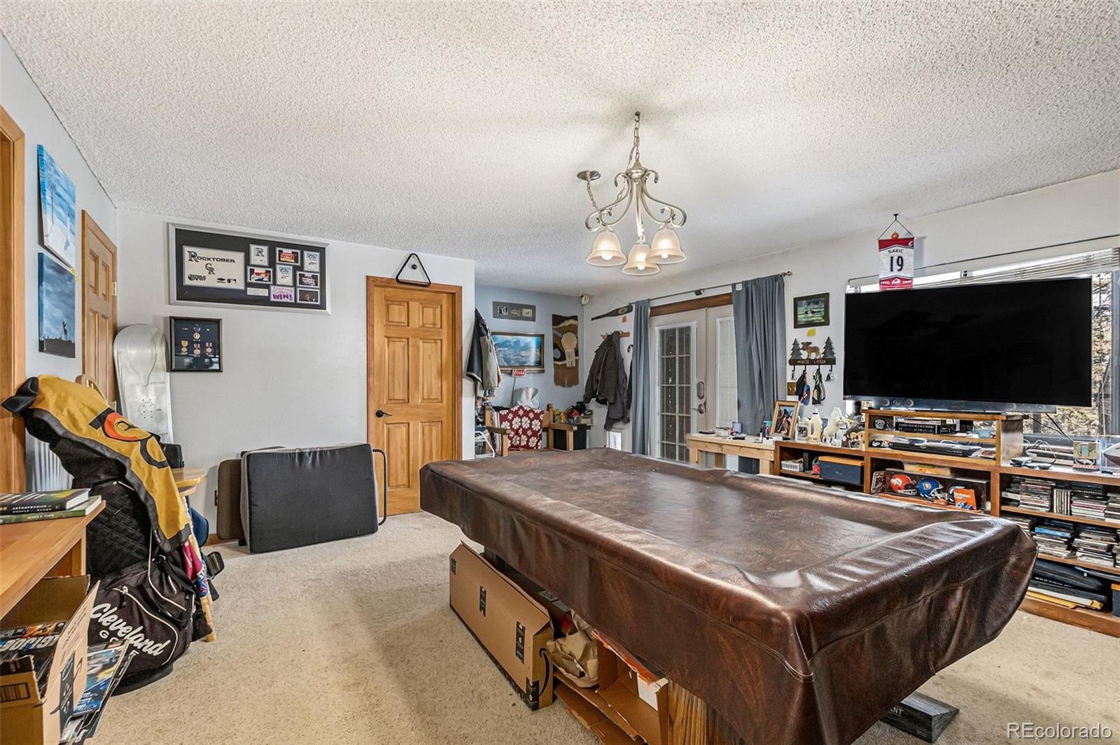 22296 Cook Lane Morrison, CO 80465 - Photo 13 of 19 a living room with stainless steel appliances furniture and a flat screen tv
