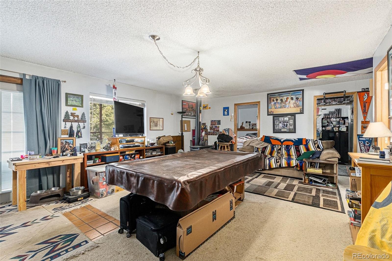 22296 Cook Lane Morrison, CO 80465 - Photo 14 of 19 a view of a livingroom with furniture and a flat screen tv