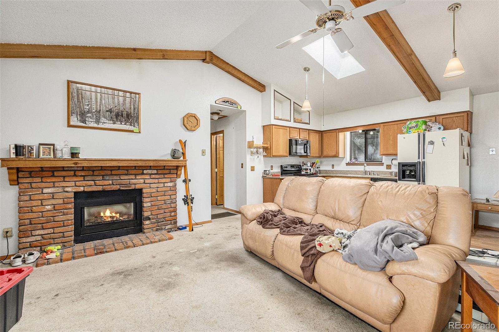 22296 Cook Lane Morrison, CO 80465 - Photo 2 of 19 a living room with furniture and a fireplace