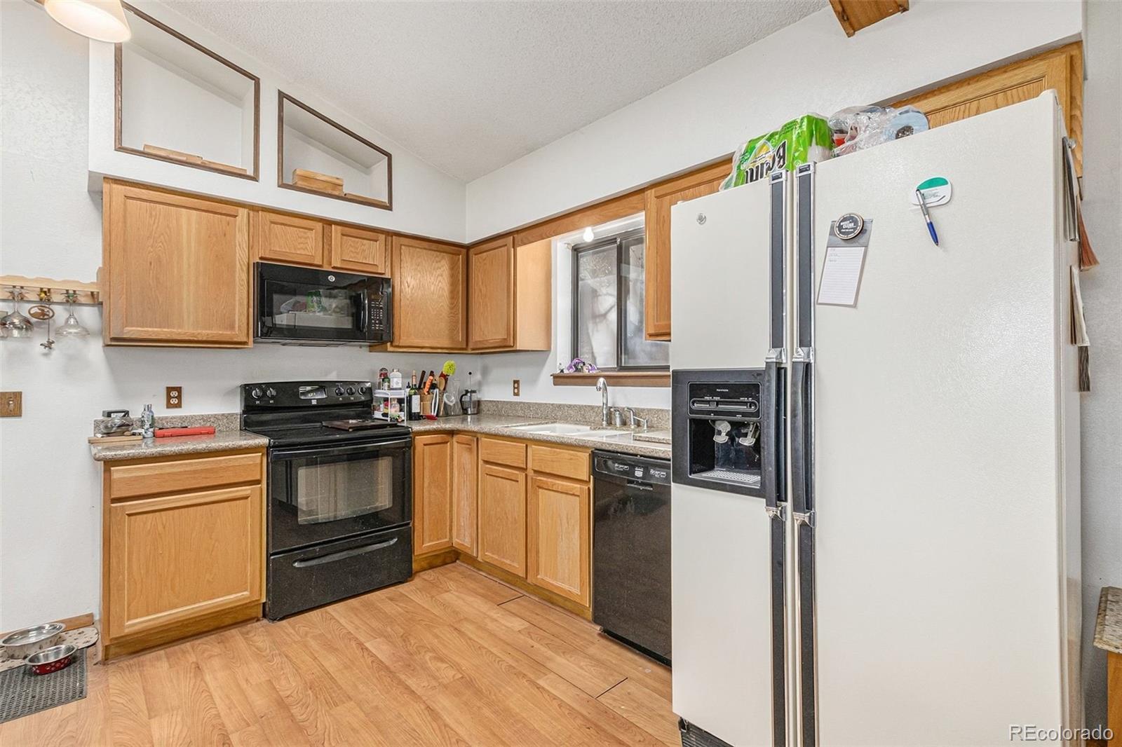 22296 Cook Lane Morrison, CO 80465 - Photo 5 of 19 a kitchen with stainless steel appliances granite countertop a refrigerator stove top oven and sink