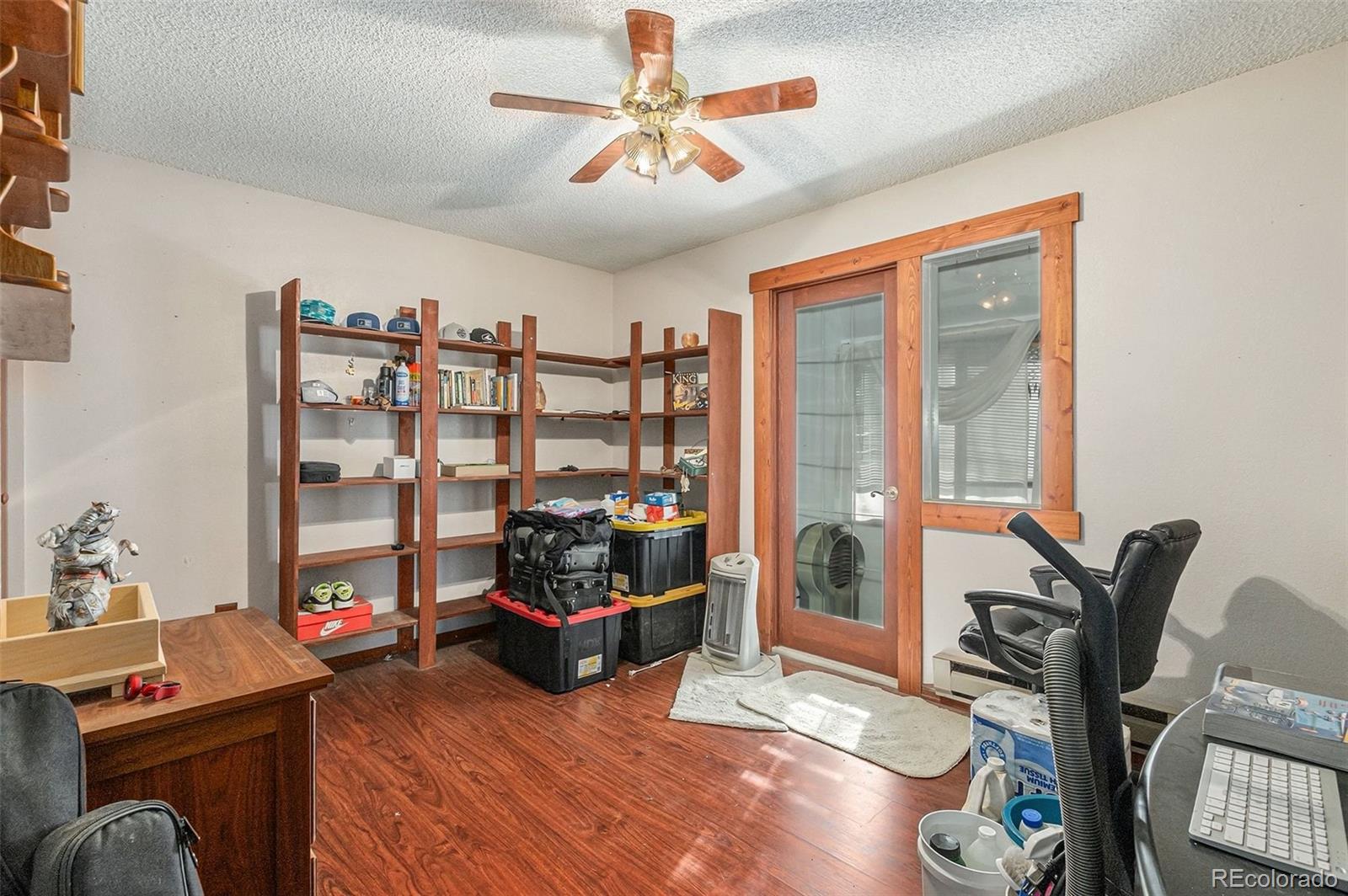 22296 Cook Lane Morrison, CO 80465 - Photo 7 of 19 a living room with furniture a rug and a chandelier