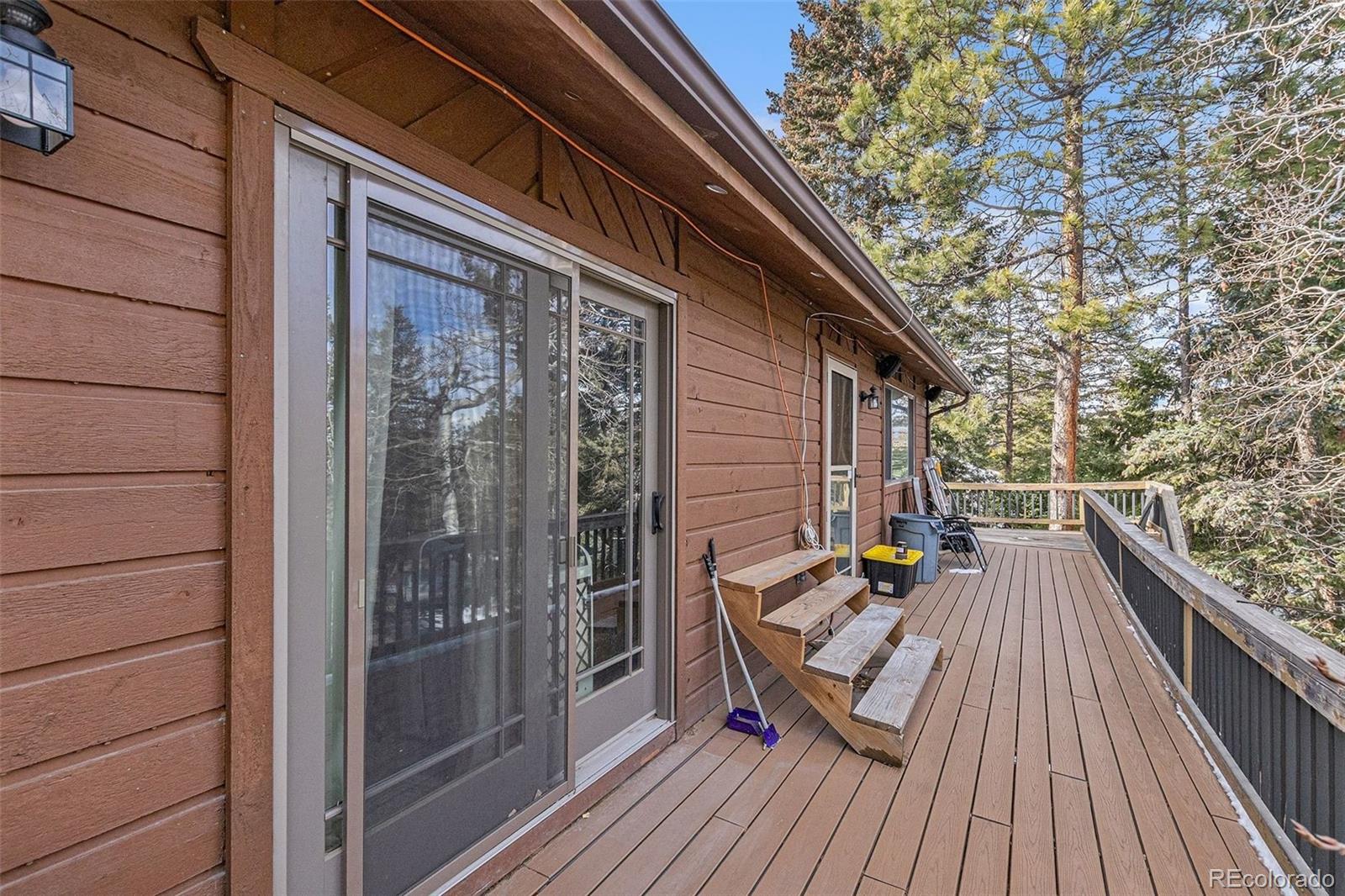 22296 Cook Lane Morrison, CO 80465 - Photo 10 of 19 a view of deck with patio