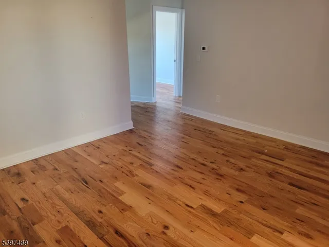 a view of a room with wooden floor