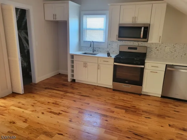 a kitchen with a sink stove and refrigerator
