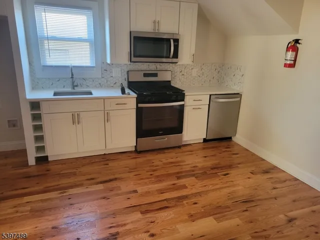 a kitchen with a sink stove and microwave