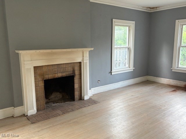 3258 Berkshire Road Cleveland, OH 44118 - Photo 5 of 23 Unfurnished living room with wood finished floors, crown molding, and a fireplace