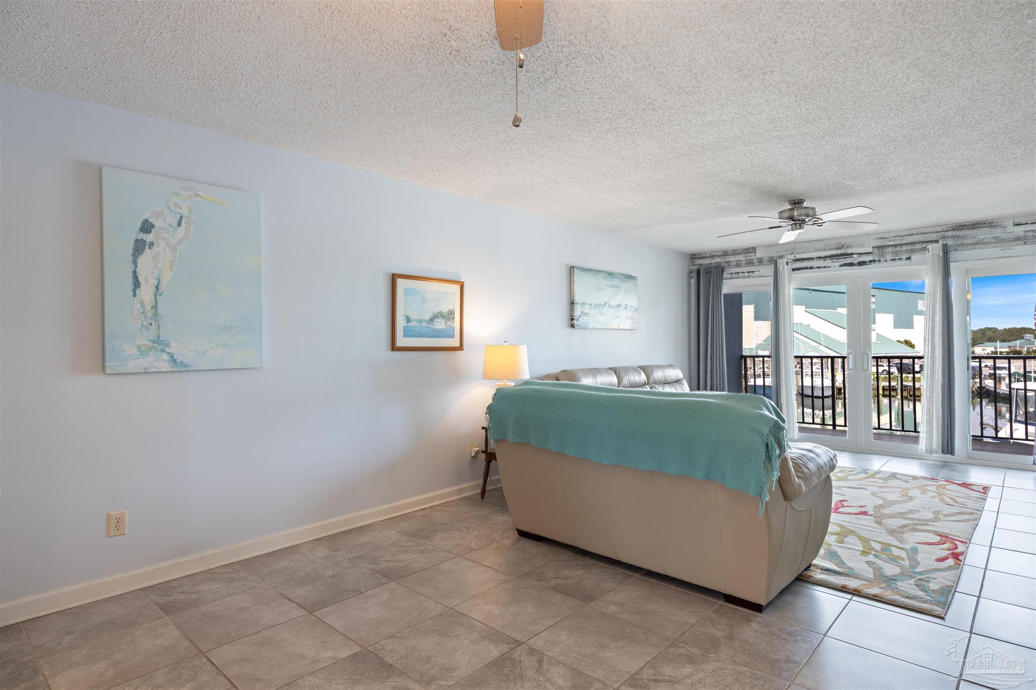 14100 River Road, Unit 228B Pensacola, FL 32507 - Photo 7 of 41 a living room with furniture and large windows