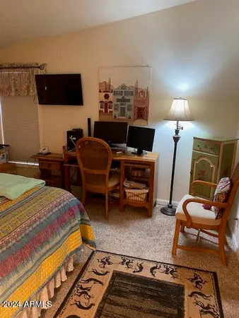 a bed room with a bed furniture and a flat screen tv