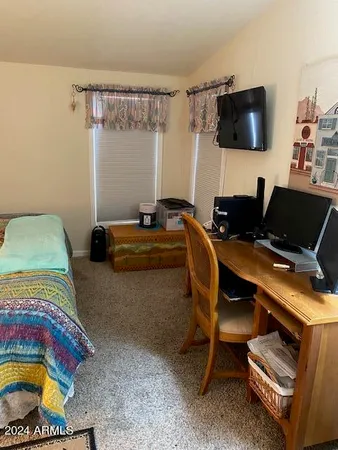 a bedroom with a bed and a flat screen tv