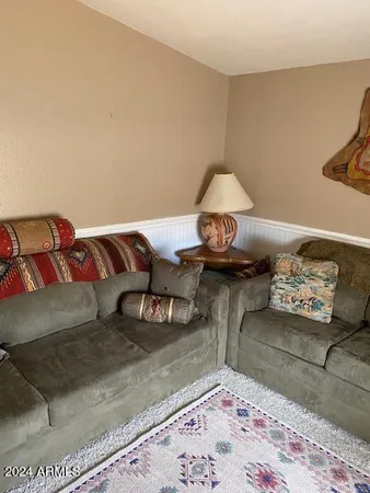 a living room with furniture and a rug