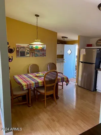 a dining room with furniture and wooden floor