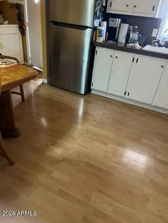 a view of a kitchen with wooden floor