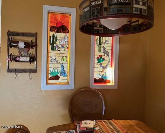 a picture of a bathroom with a painting on the wall and a window