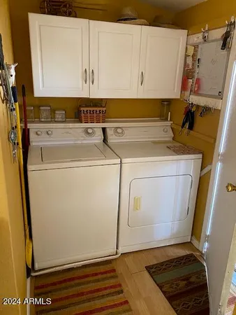 a view of a storage and utility room with washer and dryer