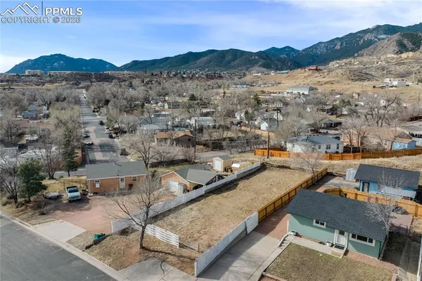 an aerial view of houses with a street