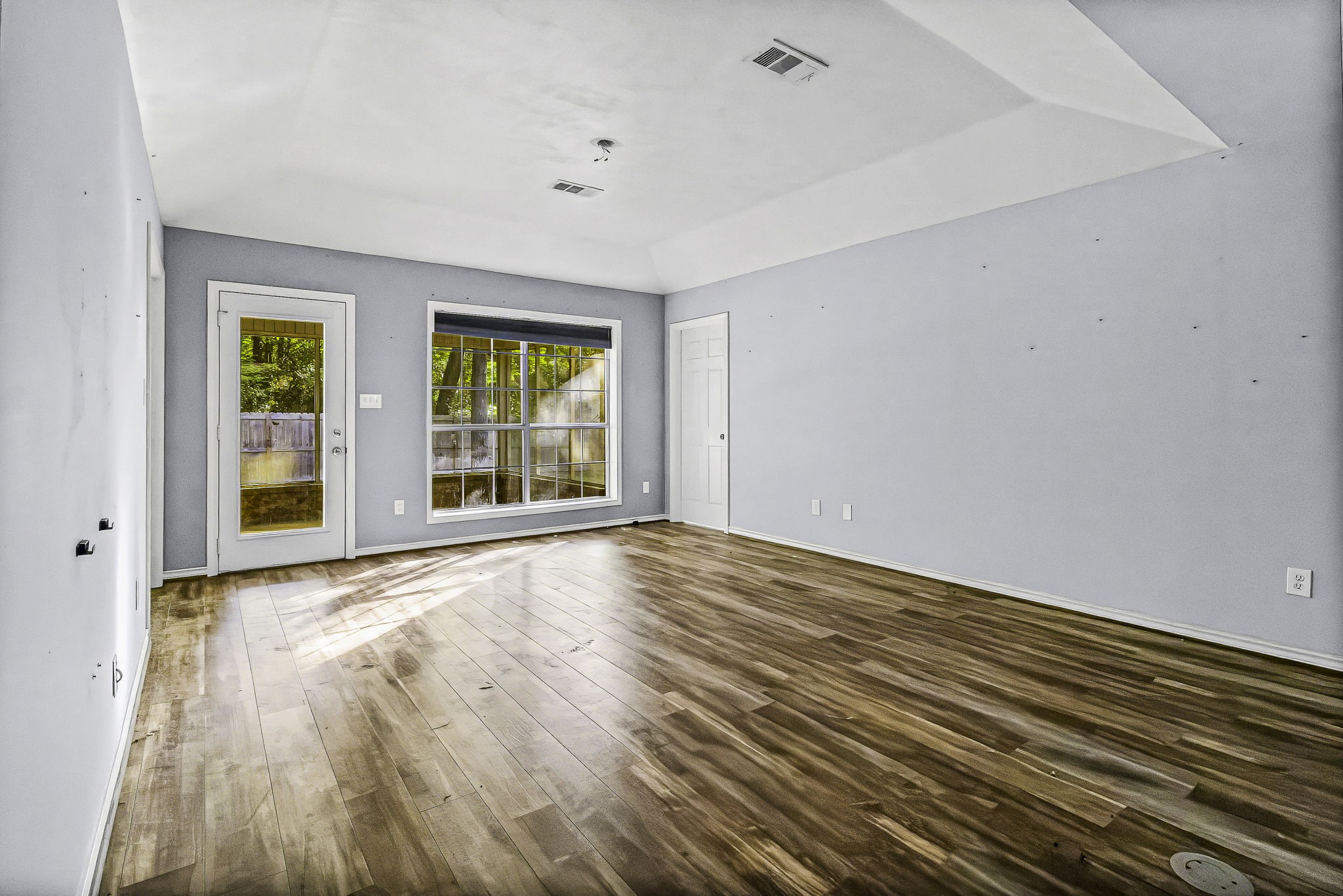 6 Lost Forest Trinity, TX 75862 - Photo 8 of 29 a view of an empty room with wooden floor and a window