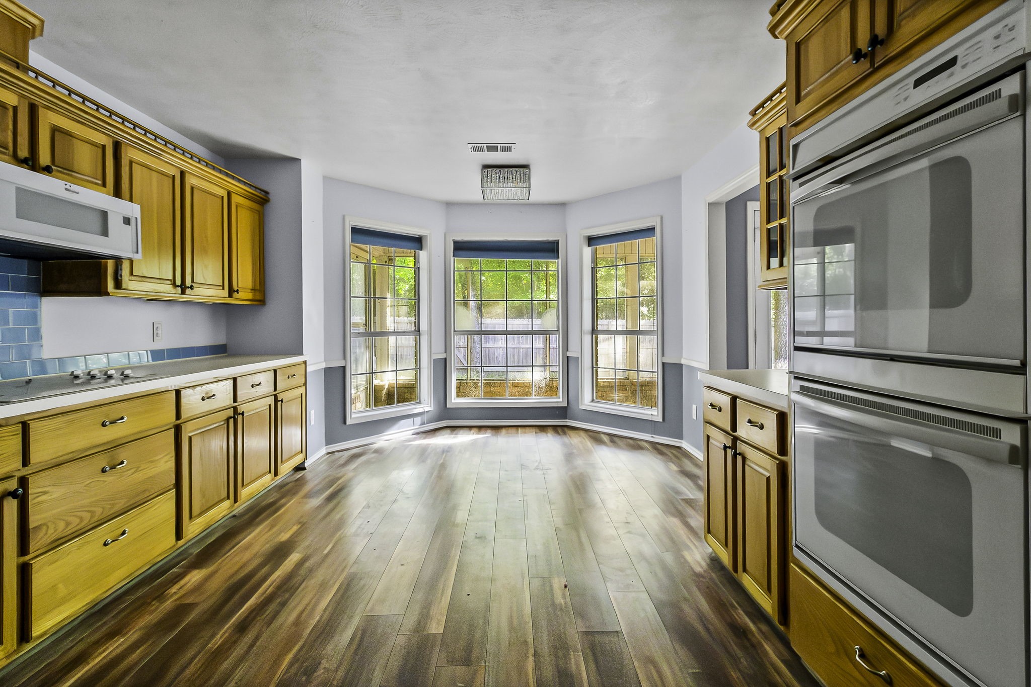 6 Lost Forest Trinity, TX 75862 - Photo 9 of 29 a view of a kitchen with wooden floor and stainless steel appliances