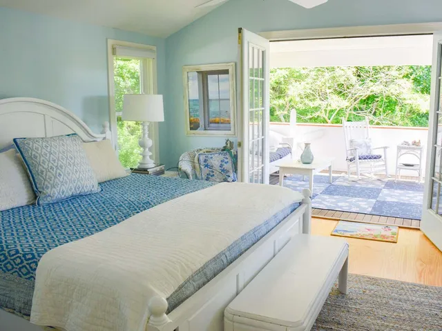 a living room with a bed furniture and a large window