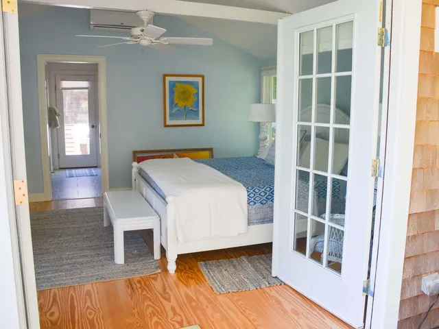 a bedroom with a bed and a window