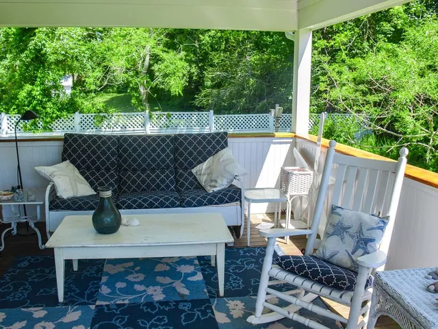 swimming pool view with a seating space