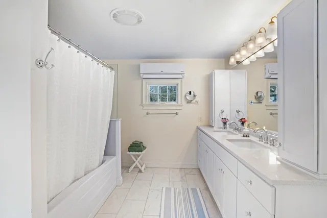 a bathroom with a sink a mirror and a shower