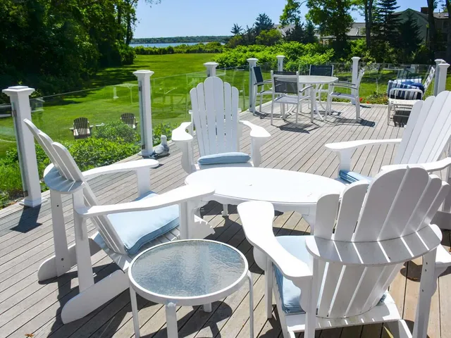 a view of a patio with a table chairs and a backyard