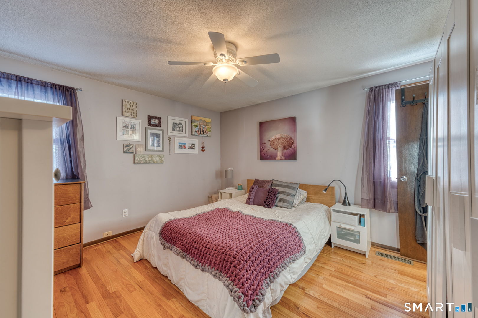 100 Spice Hill Drive Meriden, CT 06451 - Photo 17 of 39 a bedroom with a bed and a chandelier